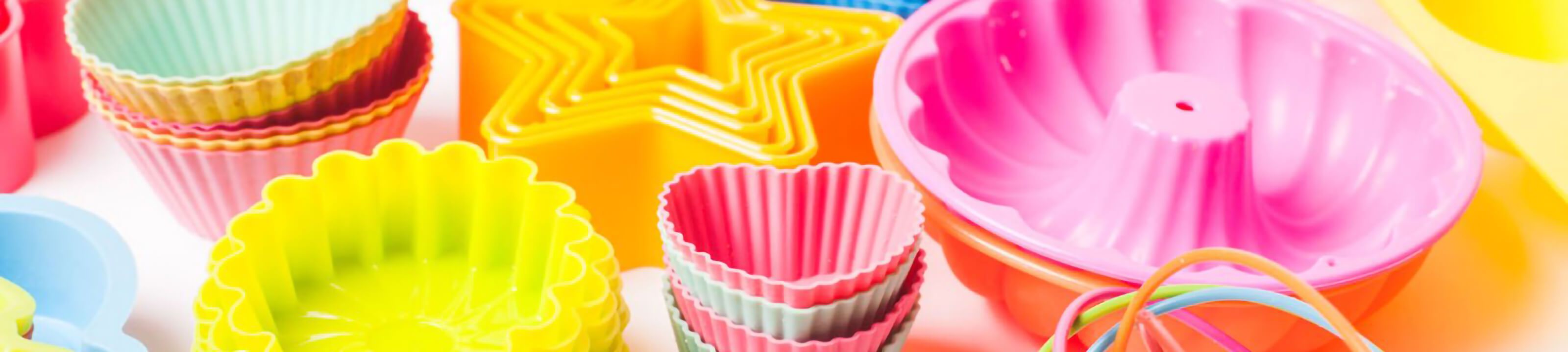 Silicone baking mat rolled on a tray next to parchment paper