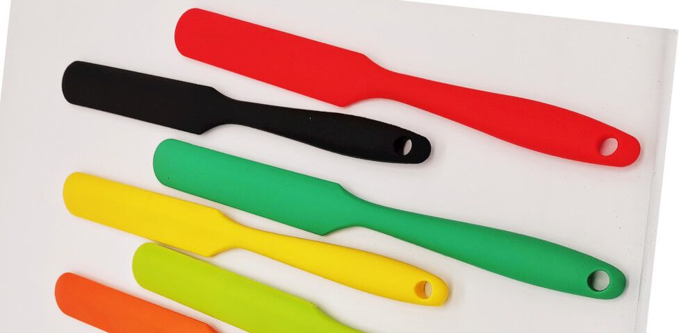 Set of silicone spatulas in custom colors with embossed logos on handles